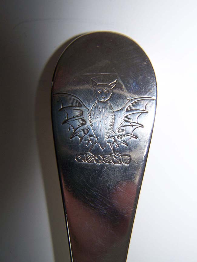 An English Queen Anne Period Silver Basting Spoon made in London in 1712 having a crest depicting a Bat.